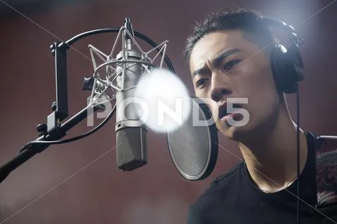 Young Man Singing In Recording Studio