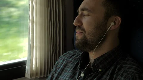 Young man singing on a way in a train. Vídeo Stock 116278655