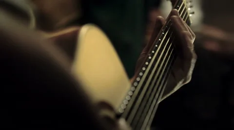 Young man is singing while is playing a guitar Stock-Footage 64512836