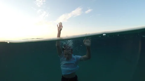 Young man sinking into the sea Stock Footage 90515227
