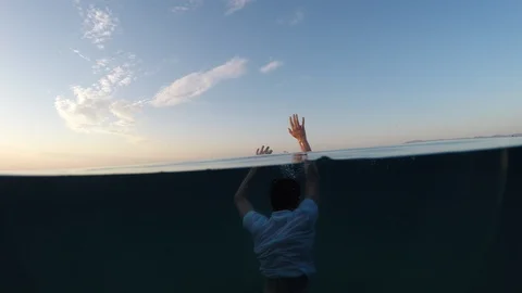 Young man sinking into the sea Stock Footage 90515239