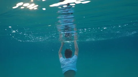 Young man sinking into the sea Stock Footage 90515276
