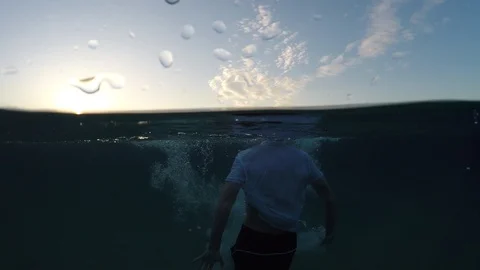 Young man sinking into the sea Stock Footage 90515453