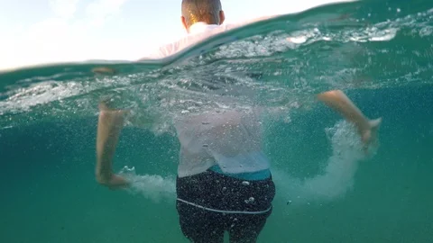 Young man sinking into the sea Stock Footage 90515744