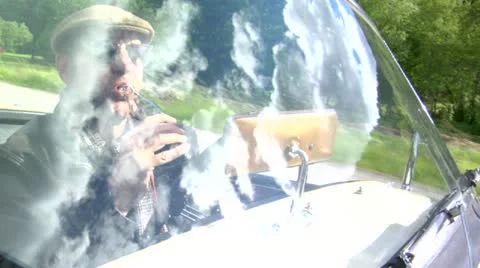 Young man sips the hot drinks while drive on the road Stock Footage 22424227