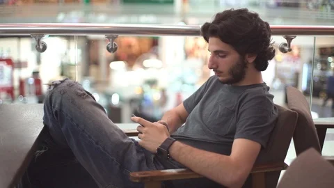 Young Man Sits and Using Phone Video stock 92069033