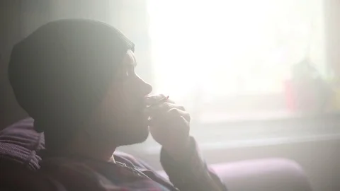 Young Man Sits Back and Smokes Joint/Marijuana - Close Up Stock Footage 78175890