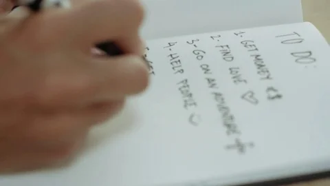 Young man sits in cafe and writes plan 스톡 동영상 76048871