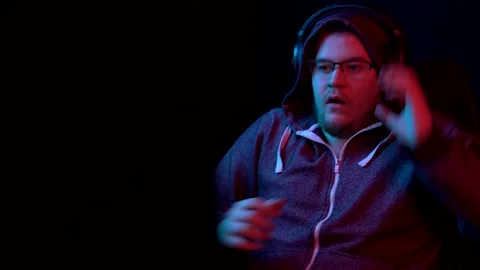 A young man sits at a computer and gets scared. Stock Footage 154130139