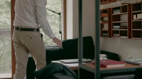 Young man sits down to work in coffee on laptop Stock Footage 159903716