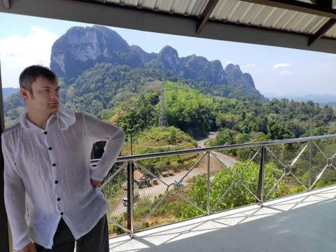 The young man sits has a rest on the observation, survey deck. A tourist in a Stock Photos