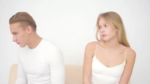 Young man sits with his back to his girlfriend offended. Stock Footage 142563977