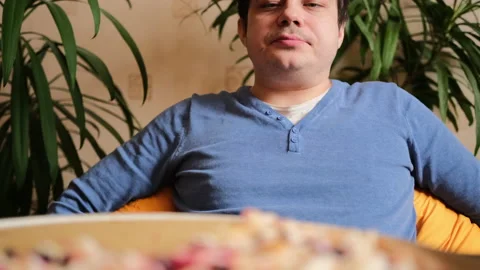 A young man sits relaxed after a delicious meal Stock-Footage 149314809