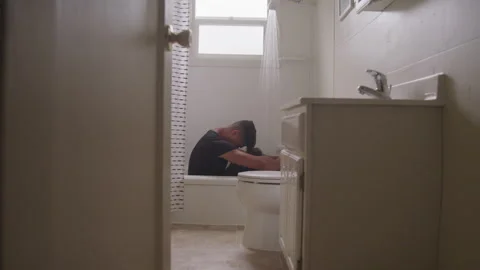 Young Man Sits In Shower Alone Vidéo 208711533