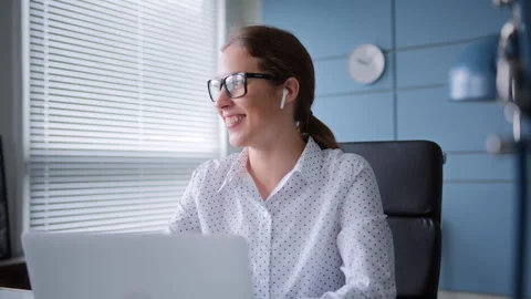 Young man sits at table with laptop in home office Video stock 260950600
