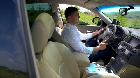 Young man sitting behind the wheel of a car Stock Footage 108117222