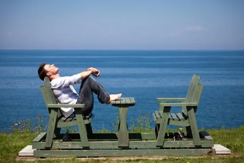 Young man sitting on the bench Stock-Fotos