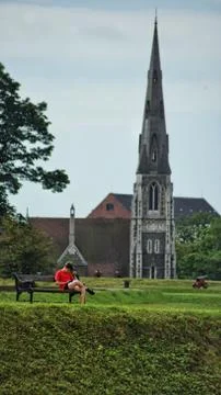 A young man sitting on a bench Foto stock