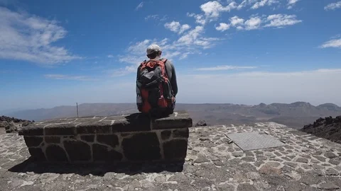 Young man sitting on bench on top watching view after hiking Stock Footage 116659880