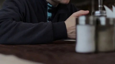 Young man sitting in cafe and using a cellphone Video stock 74434522