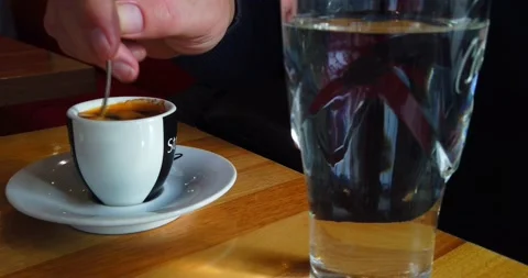 Young man sitting in the cafe and drinking coffee Stock Footage 170257425