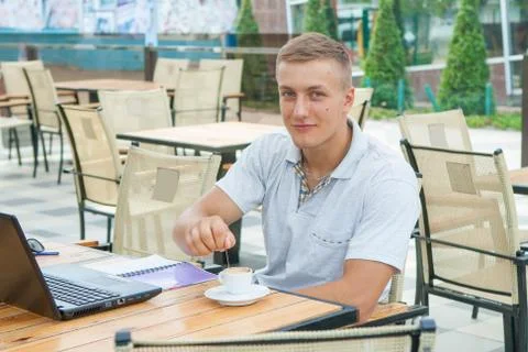 Young man sitting in cafe Stock Photos
