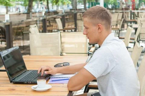 Young man sitting in cafe Stock Photos