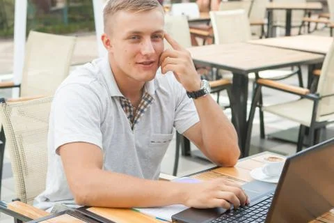 Young man sitting in cafe Stock Photos