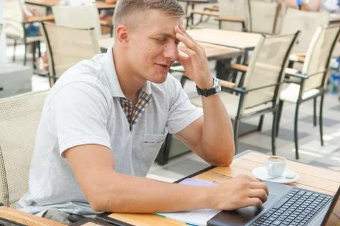 Young man sitting in cafe Stock Photos