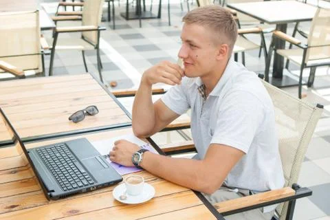 Young man sitting in cafe Stock Photos