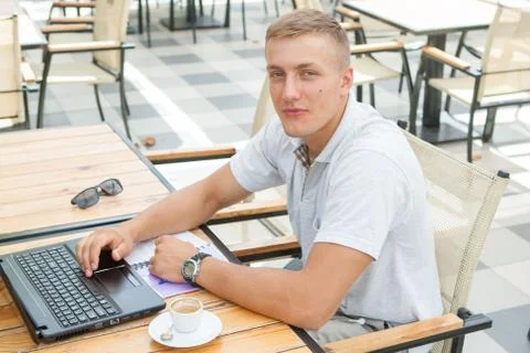 Young man sitting in cafe Stock Photos
