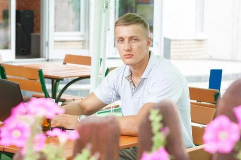 Young man sitting in cafe Stock Photos