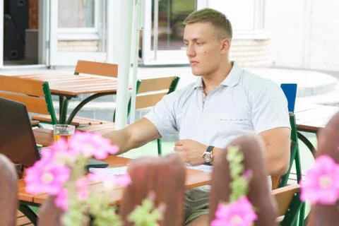 Young man sitting in cafe Stock Photos