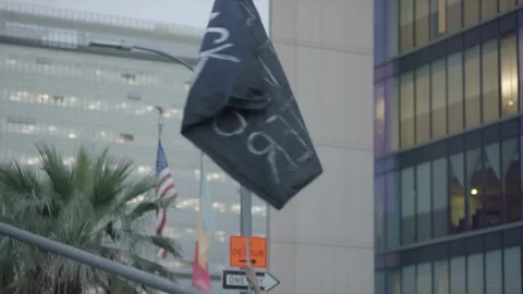 Young man sitting on a car with a flag, BLM, Downtown, LA, June 3 2020 Stock Footage 136749491