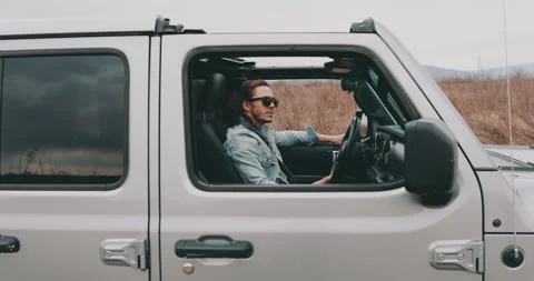 A young man is sitting in a car Stock Footage 240702683