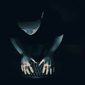 Young man sitting at a computer in the dark. 3d render Stock Illustration