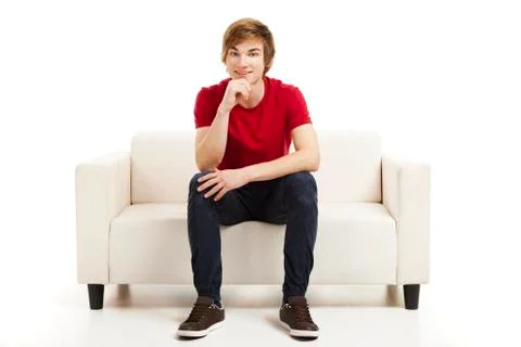 Young man sitting on the couch Stock Photos