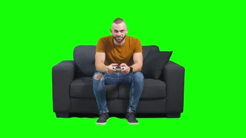 Young man sitting on couch, playing video games and losing Video stock 136369289