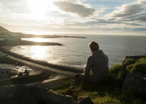 Young Man Sitting Down And Looking At Olafsvik,silhouette Opportunity Searching Stock Photos