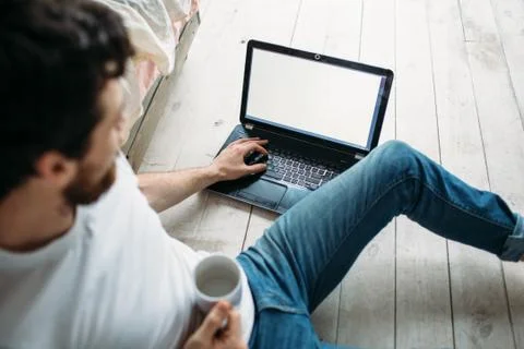Young man sitting down on the floor Stock Photos