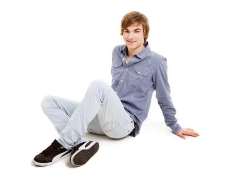Young man sitting on the floor Stock Photos