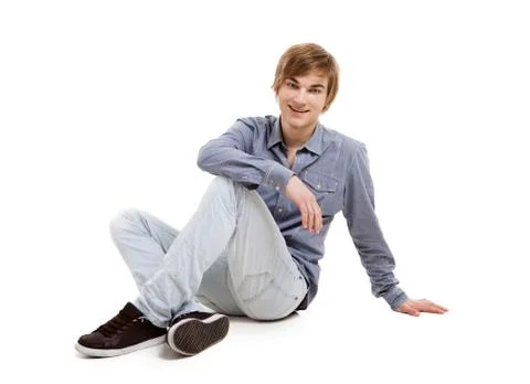 Young man sitting on the floor Stock Photos