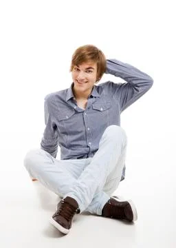 Young man sitting on the floor Stock Photos