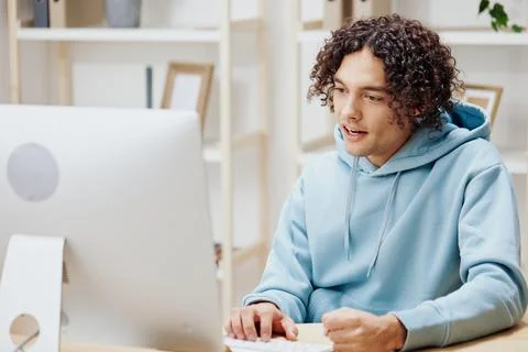 A young man sitting in front of the computer work at home Lifestyle 스톡 사진