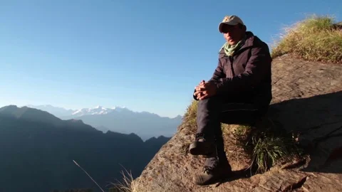 Young man sitting on the mountain Stock Footage 82331293