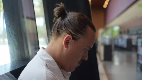 Young Man Sitting Near Window in Library, Side Profile in... 動画素材 334436920