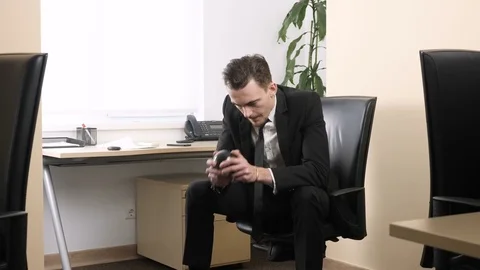 Young man sitting in office shaking Magic Eight Ball and receives a positive Stock Footage 83683587