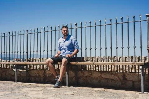 Young man sitting Stock Photos