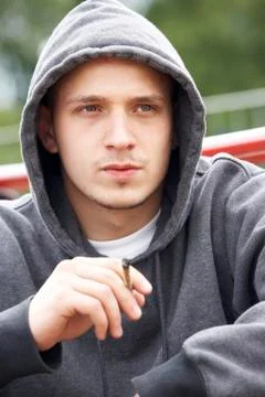 Young Man Sitting In Playground Smoking Joint Stock Photos
