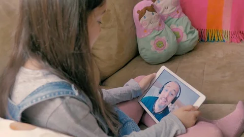 Young man sitting on sofa and very happy talking to dad by video call Stock Footage 128671776